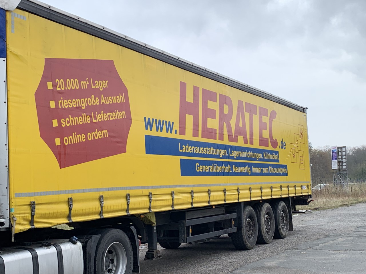 Auflieger von einem LKW mit Heratec Aufschrift für den Transport von Waren.